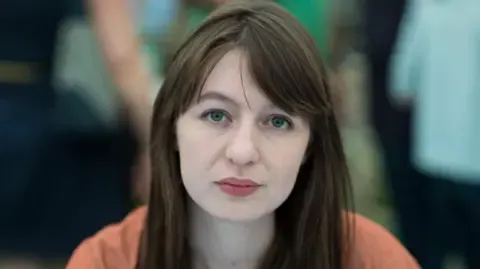 The acclaimed novelist claims she is unable to visit the UK over potential arrest